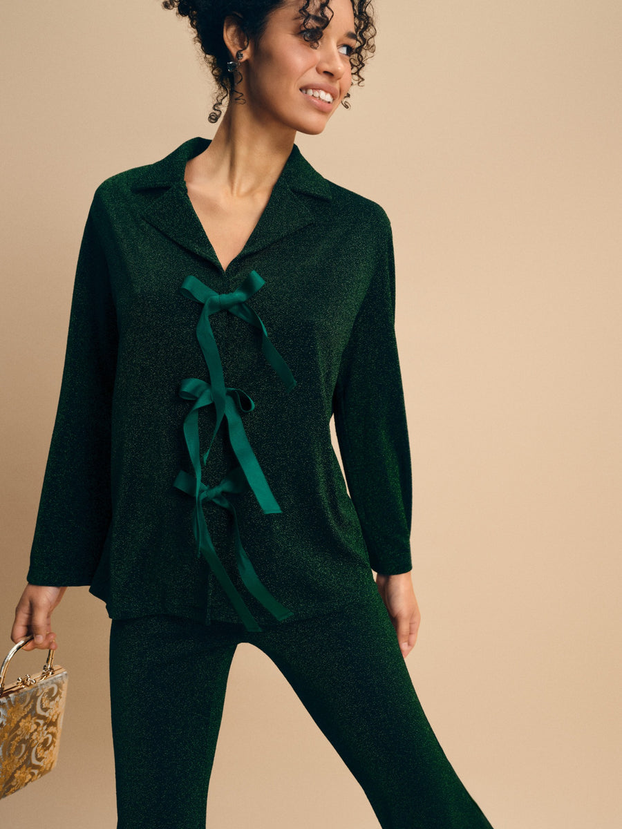 Stardust Lurex Lounge Suit in Green — close-up of bows and fabric